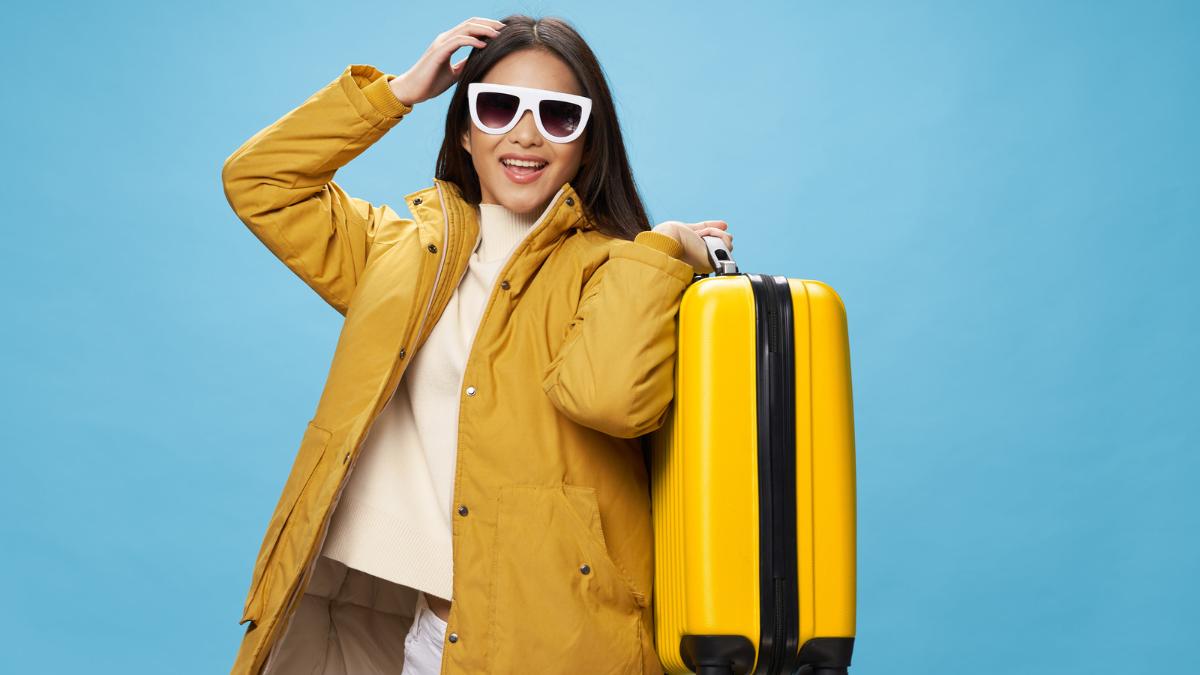 girl with coat and suitcase