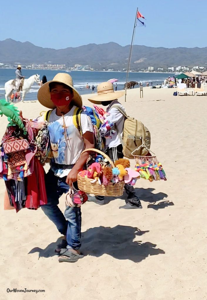 Vendors selling souvenirs in front of a Puerto Vallarta hotel.