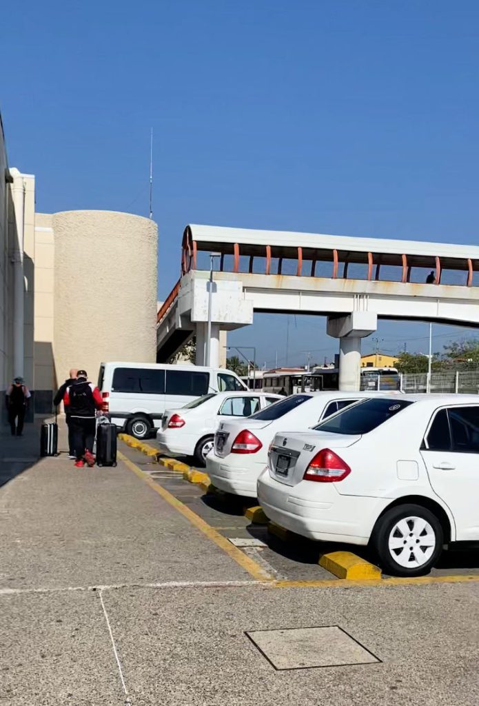 Cross the pedestrian bridge at the Puerto Vallarta airport to meet your Uber driver on the other side of the road.
