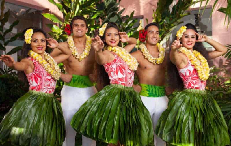Male and female dancers in Hawaiian costume at the Aha 'Aina Luau