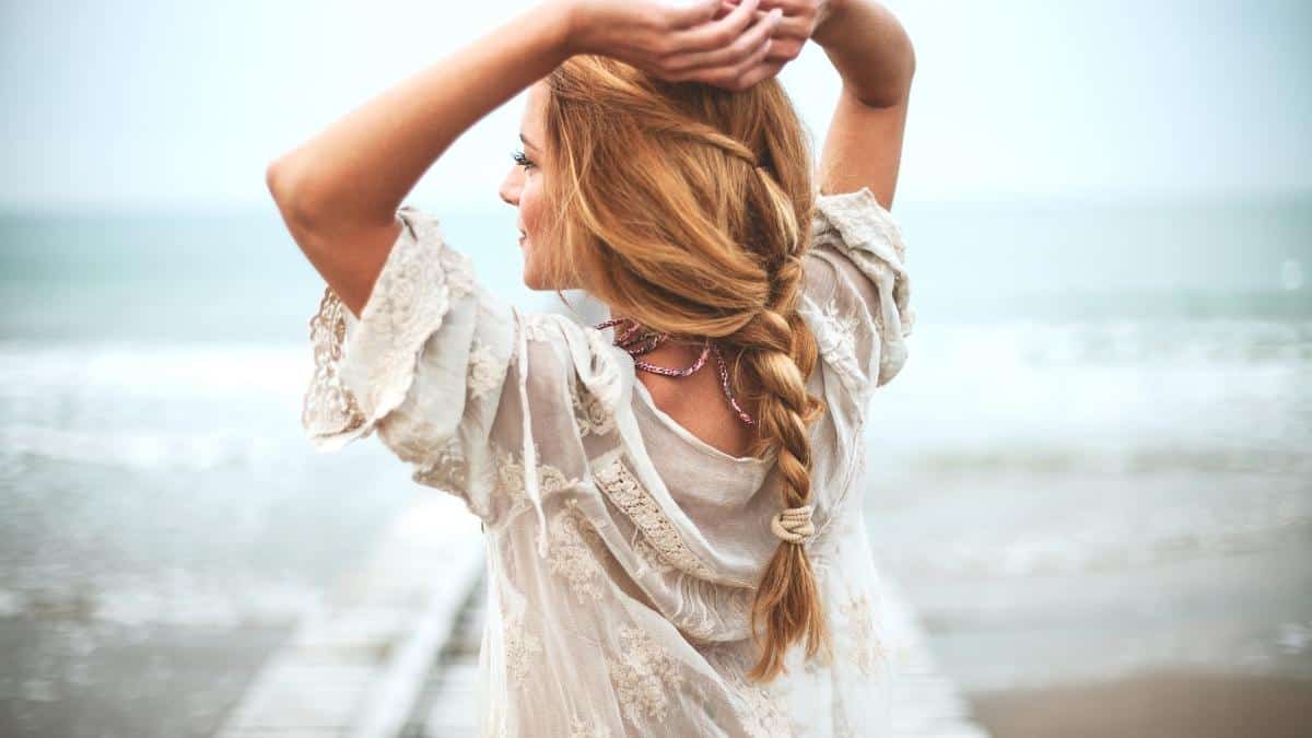 girl on beach in white shirt