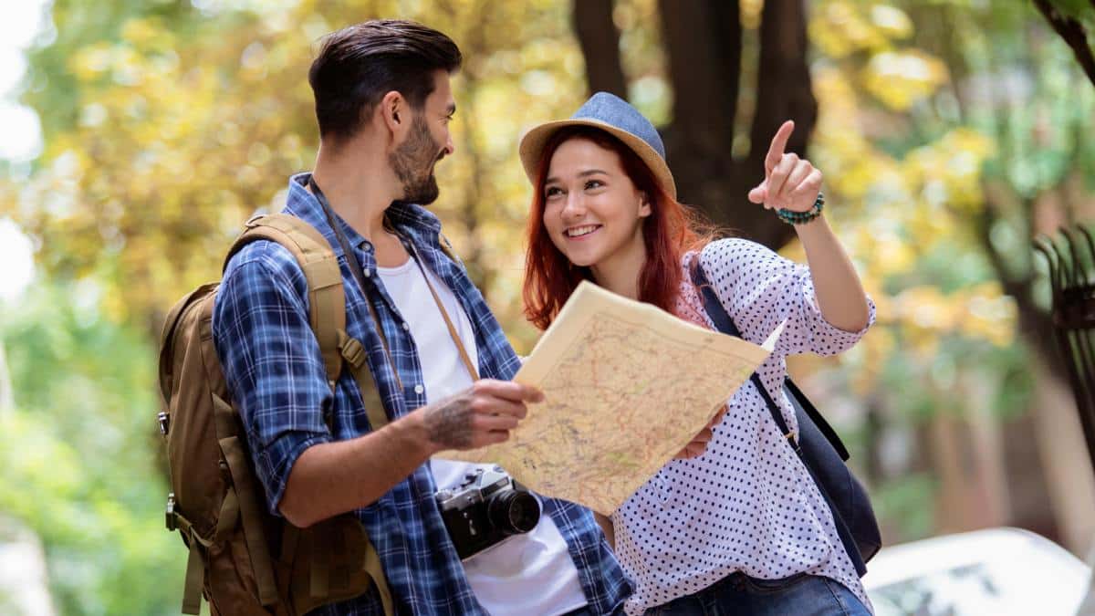 man and woman hiking with map