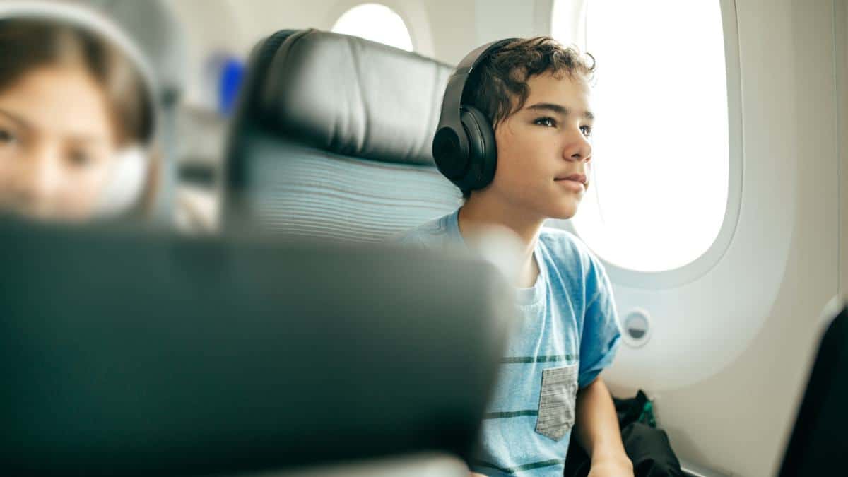 boy with headphones on airplane