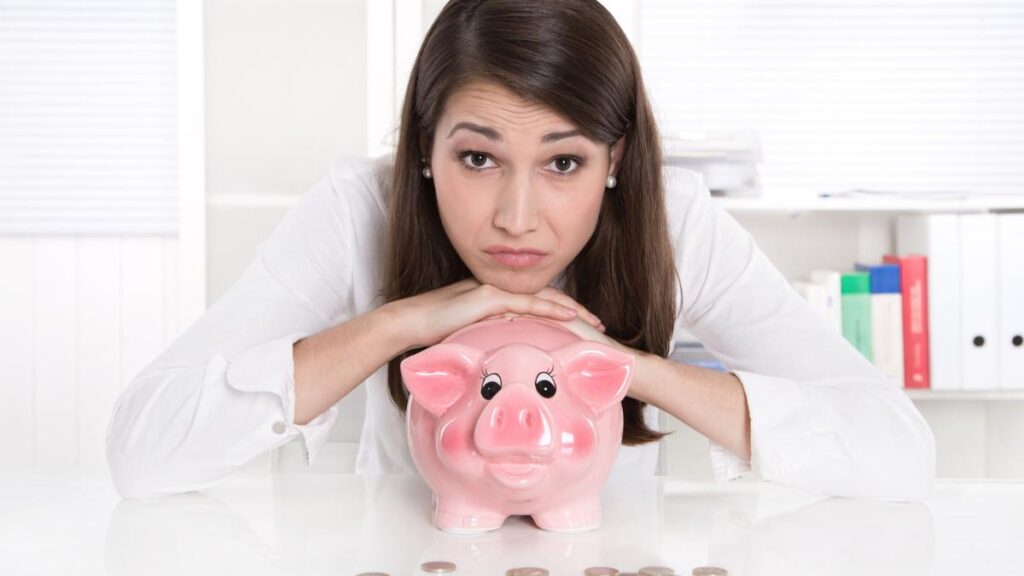 sad woman with piggy bank