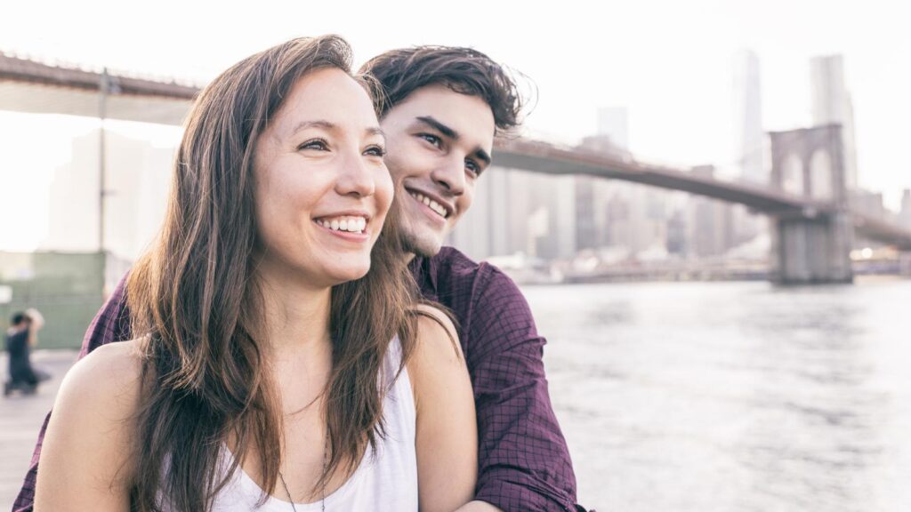 young couple by Brooklyn bridge