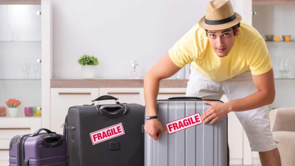 Man going on vacation with fragile suitcases.