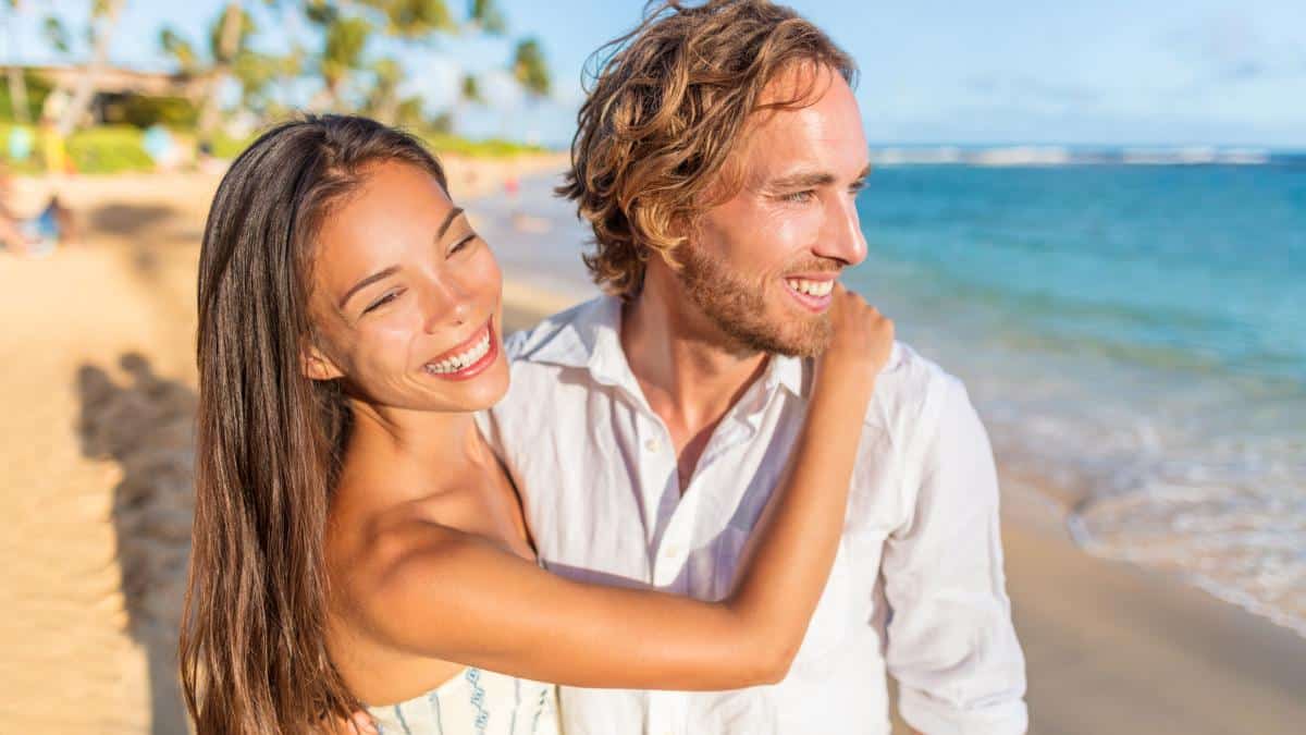 couple on beach smiling
