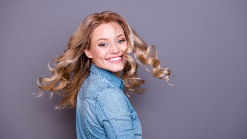 girl smiling twirling hair