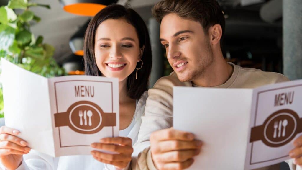 man and woman restaurant menus