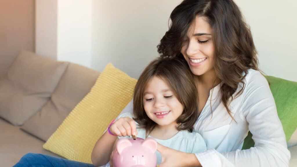 mom and daughter with piggy bank