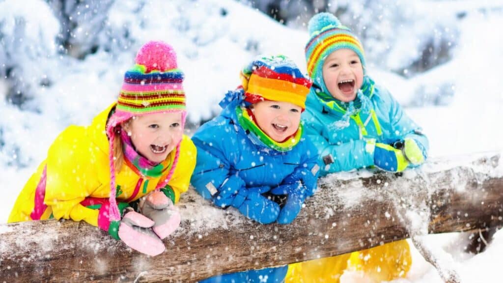 three kids playing in snow