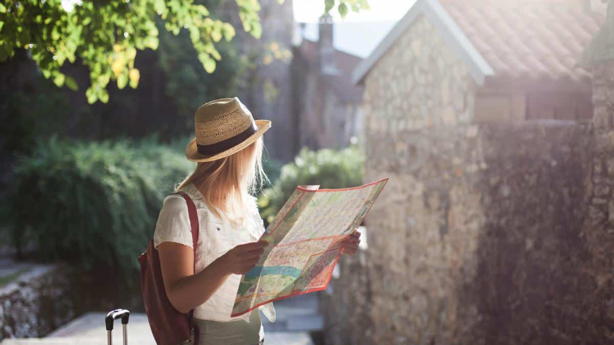 woman with hat looking at map