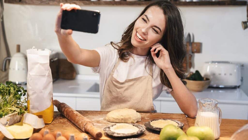 young mom cooking with smart phone