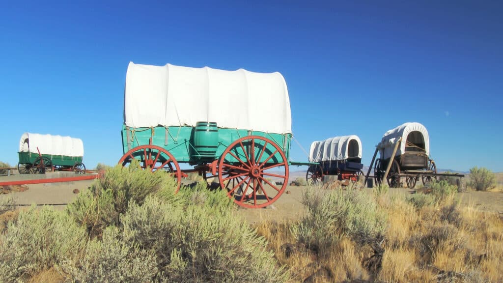 A covered wagon train forms a protective circle to camp along the Oregon Trail in eastern Oregon