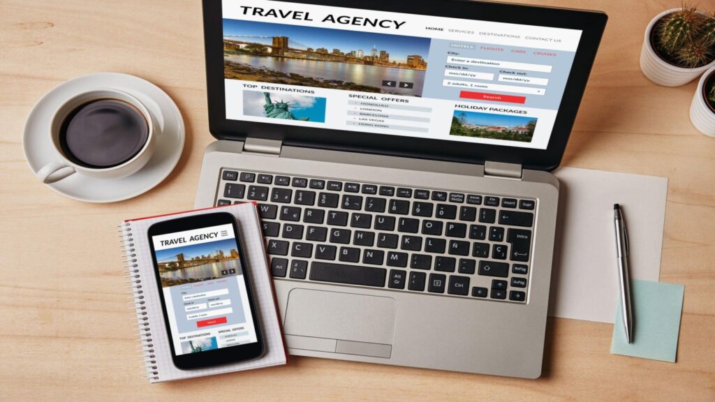 Travel agency concept on laptop and smartphone screen over wooden table. All screen content is designed by me. Flat lay