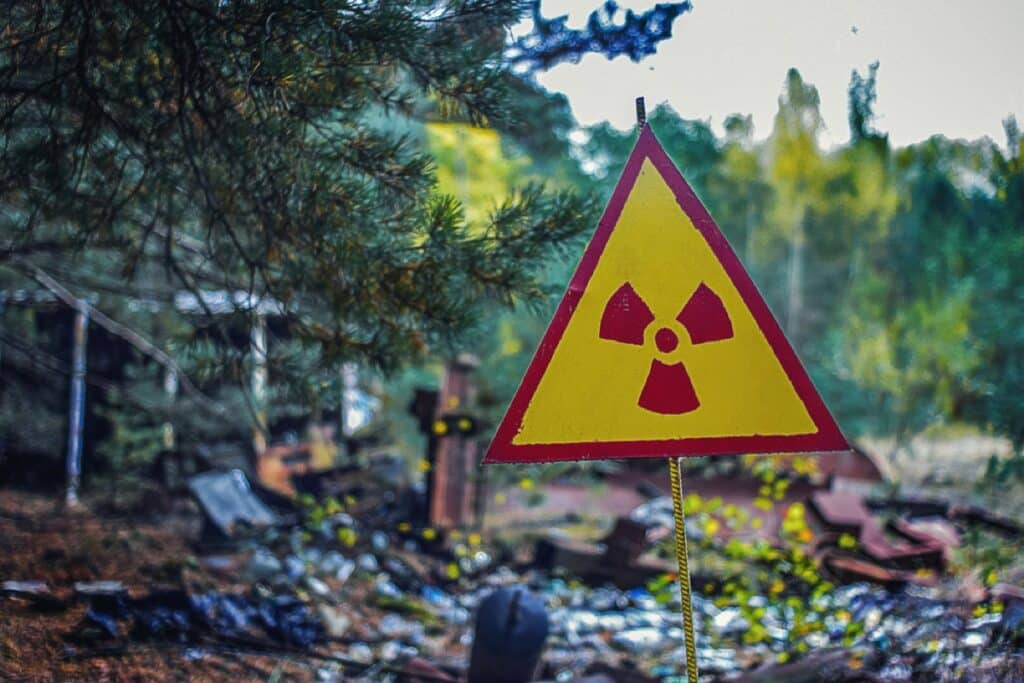 sign of a radioactive danger on an old dump of contaminated waste after a catastrophe