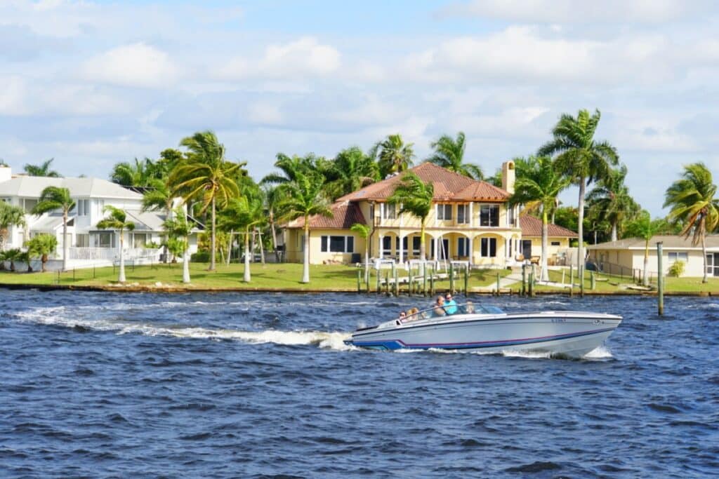 The view of the boat and waterfront home by the bay in one of the wealthiest towns in America