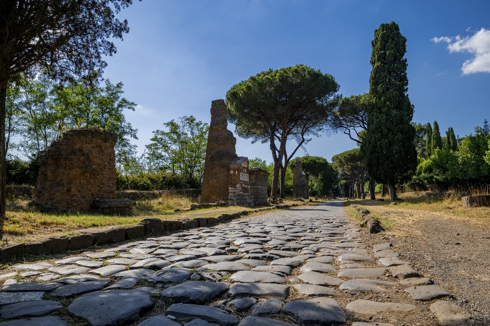 View of the paving of the Appia Antica one of the most important consular roads of Roman civilization. On the side the remains of the brick tomb This road connected Rome to Brindisi. Italy.