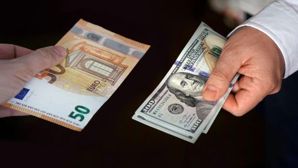 women hands exchanging European banknotes and American dollar money. concept of currency exchange.