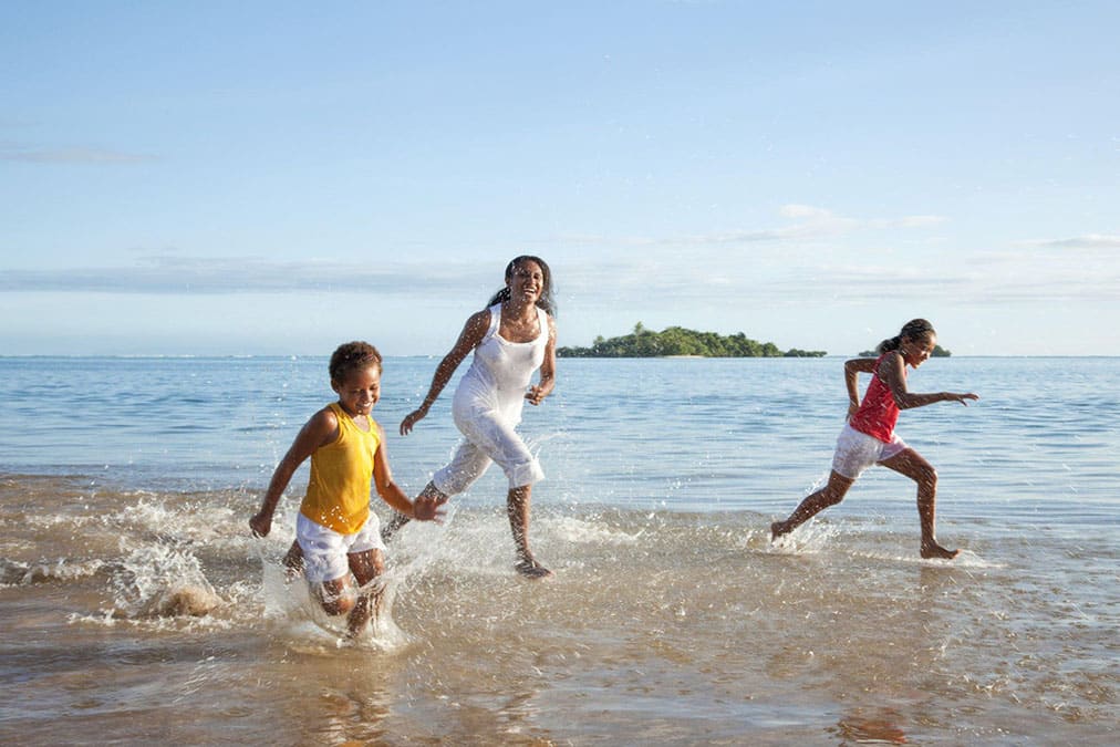 Fijian Mother and Daughters Running on Beach