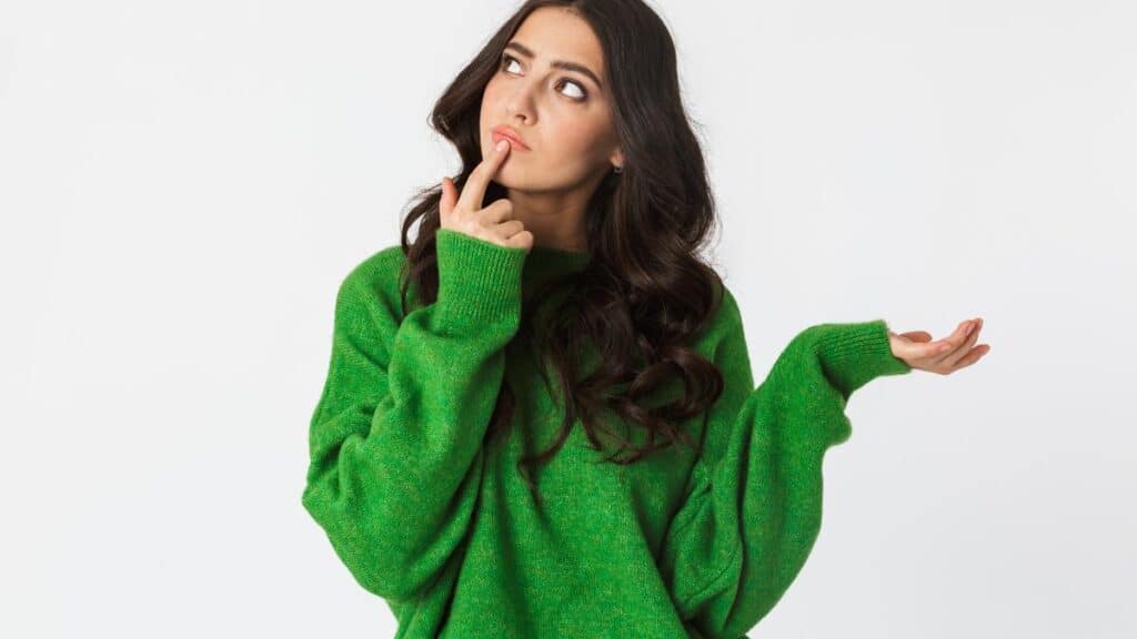 thoughtful woman in green sweater