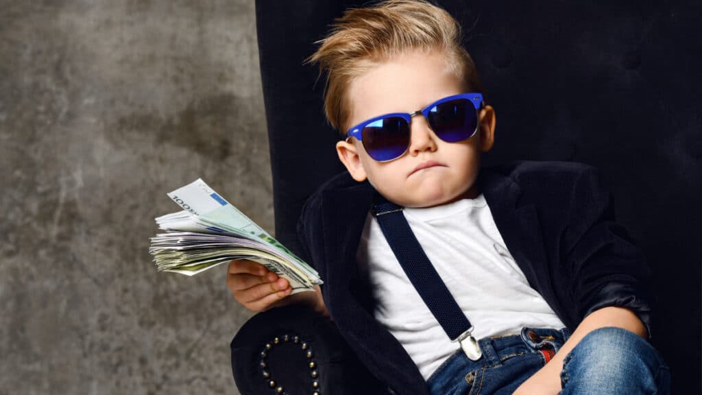 little boy with money in chair