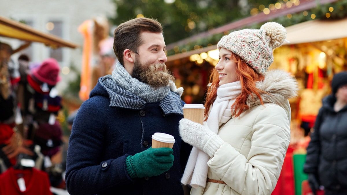 man and woman at Christmas market - Ground PictureShutterstock