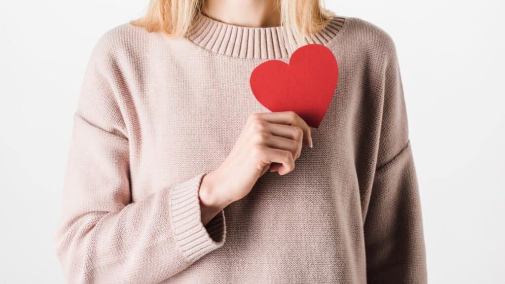 woman holding paper heart