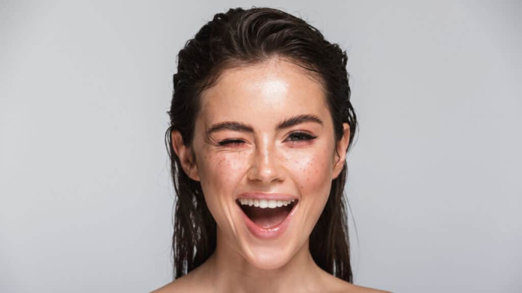girl with wet hair winking