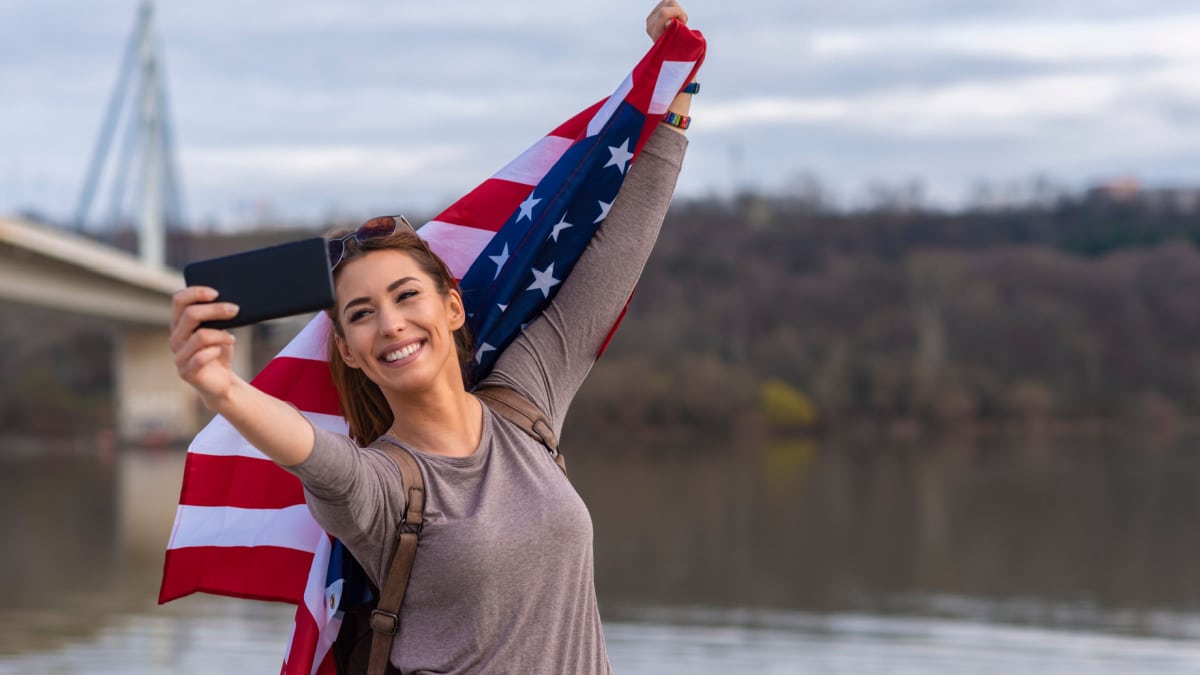 American woman tourist with flag