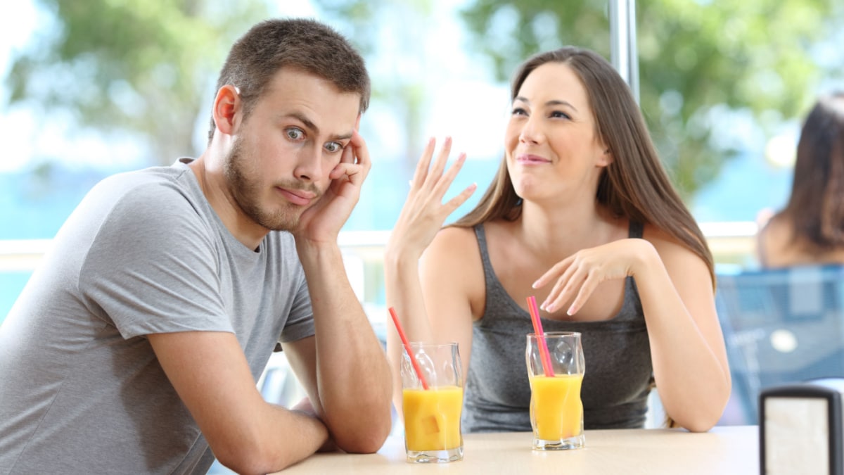 bored man listening to woman talk