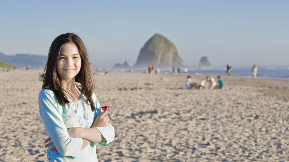 young woman at cannon beach near haystock rock