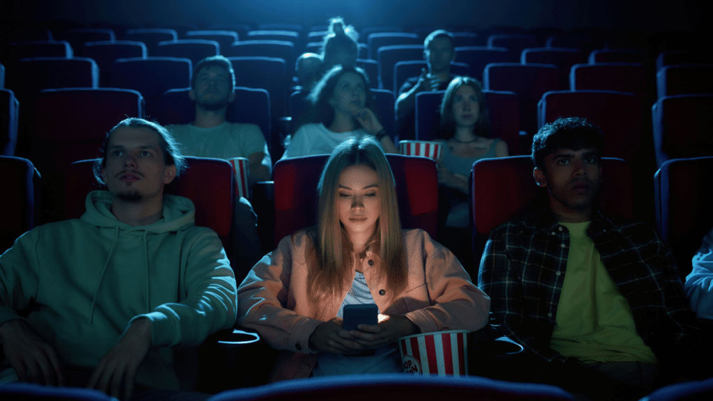 Woman using her phone in Theaters