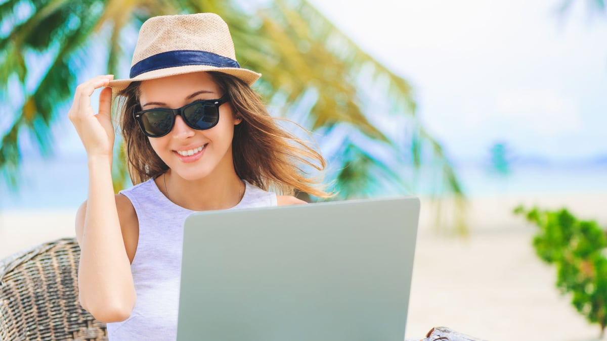 woman with laptop at beach