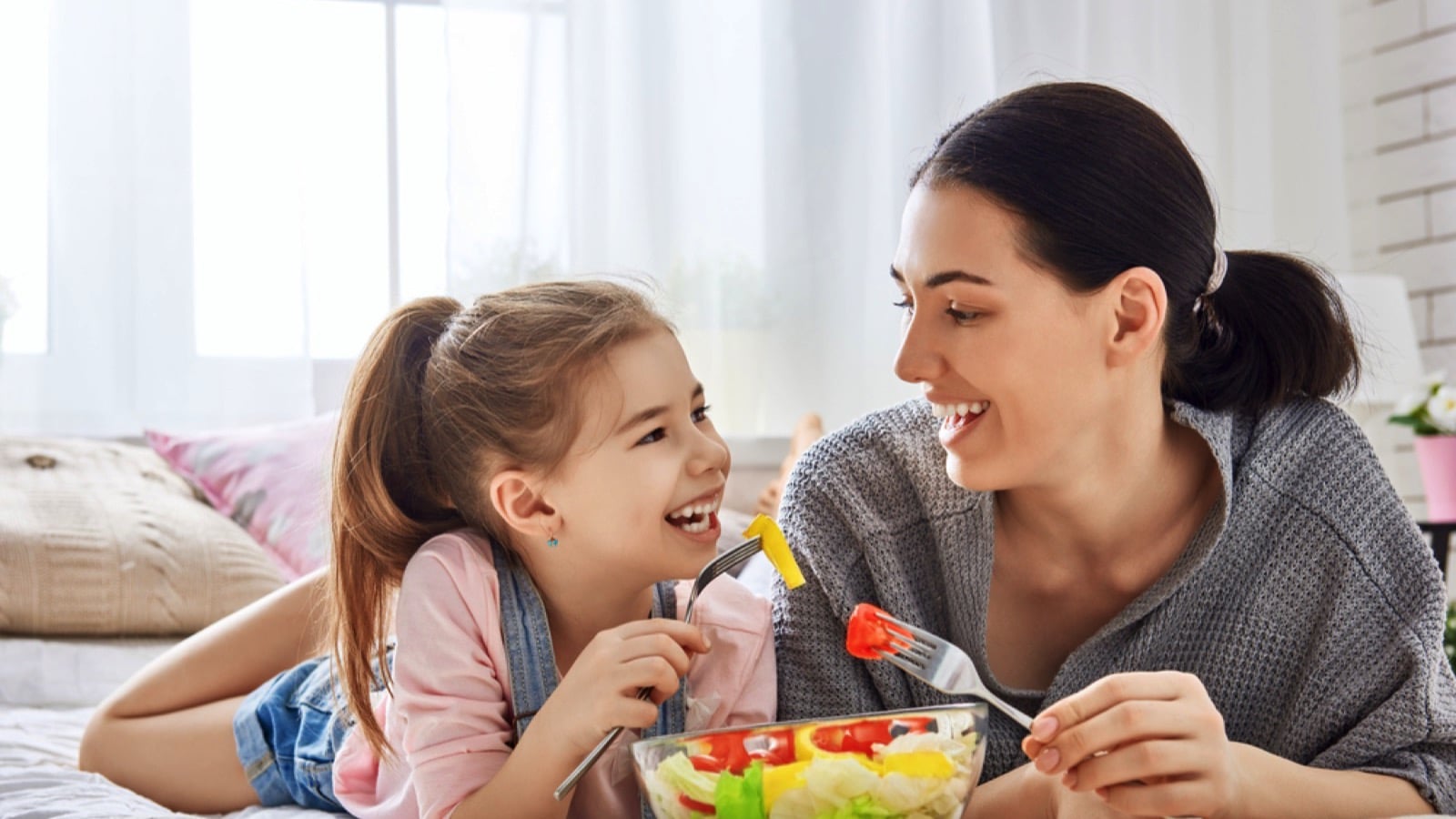 Mother and kid eating salad