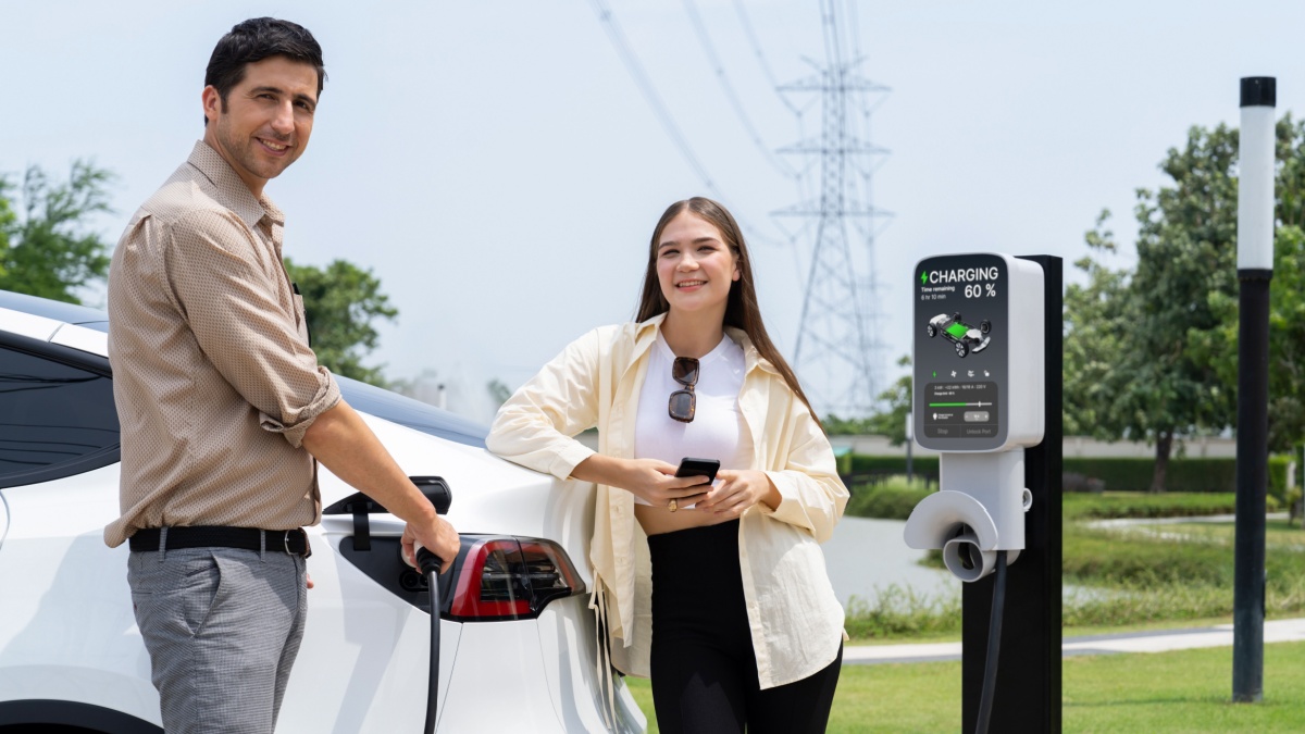 man and woman charging ev car - Owlie ProductionsShutterstock