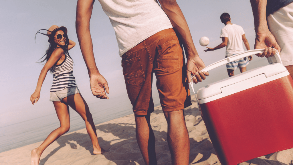two men carrying plastic cooler