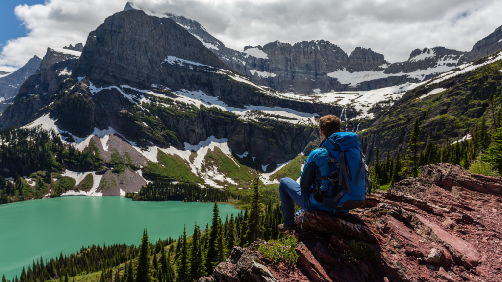 Hiker in glacier national park enjoying