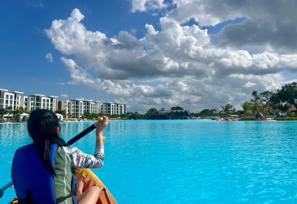 young girl kayaking on blue water