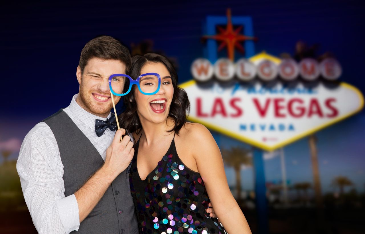 man and women in front of Las Vegas sign